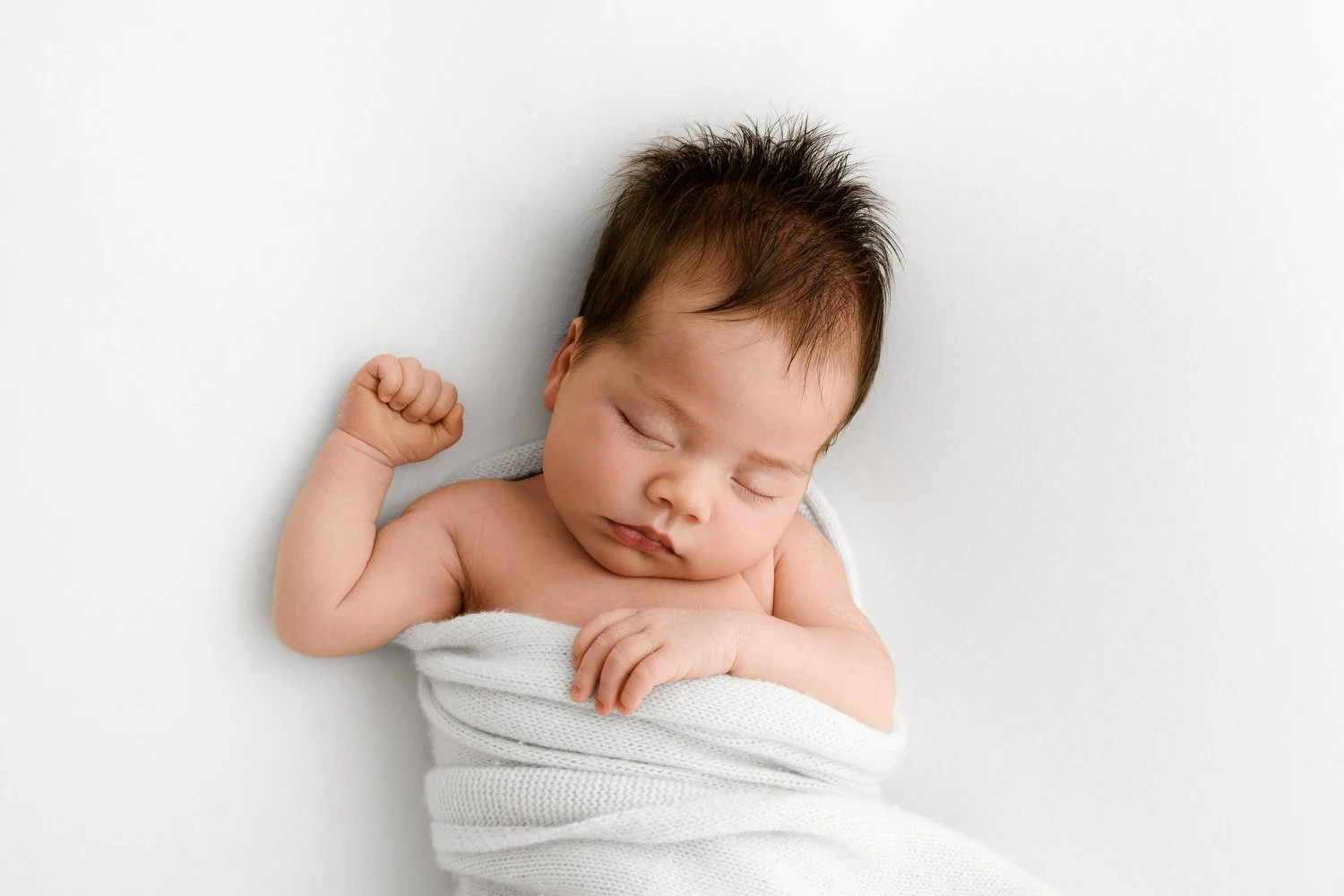 Sleeping newborn baby settled on beanbag by Ally Stuart-Ross Mabel and Moose Education