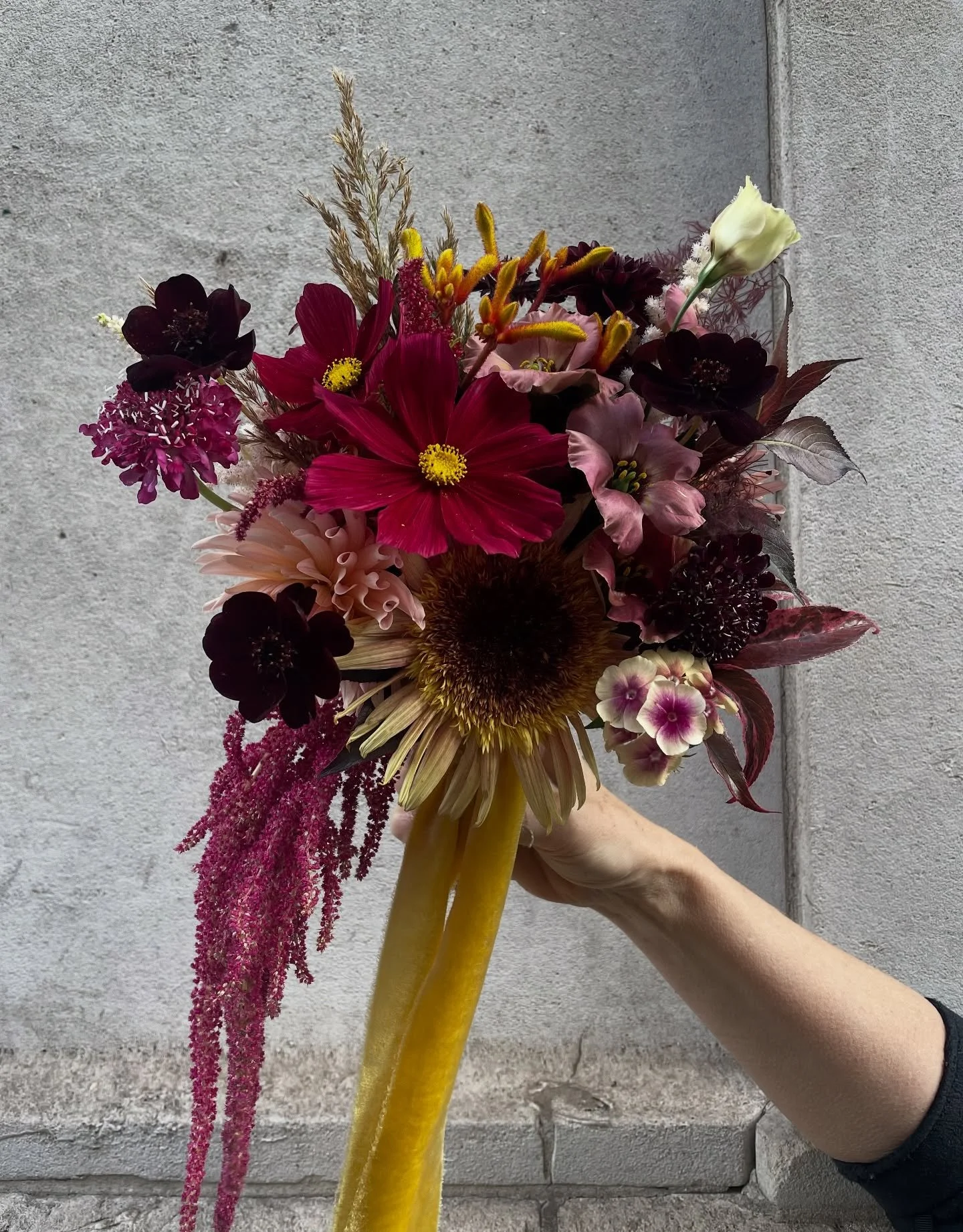 Moody, textured, and wrapped in velvet&hellip; 💛

This bouquet was a love letter to autumn,  jewel-toned blooms with golden accents, trailing amaranthus and soft, abundant textures - the kind of flowers that feel as rich and layered as the season it