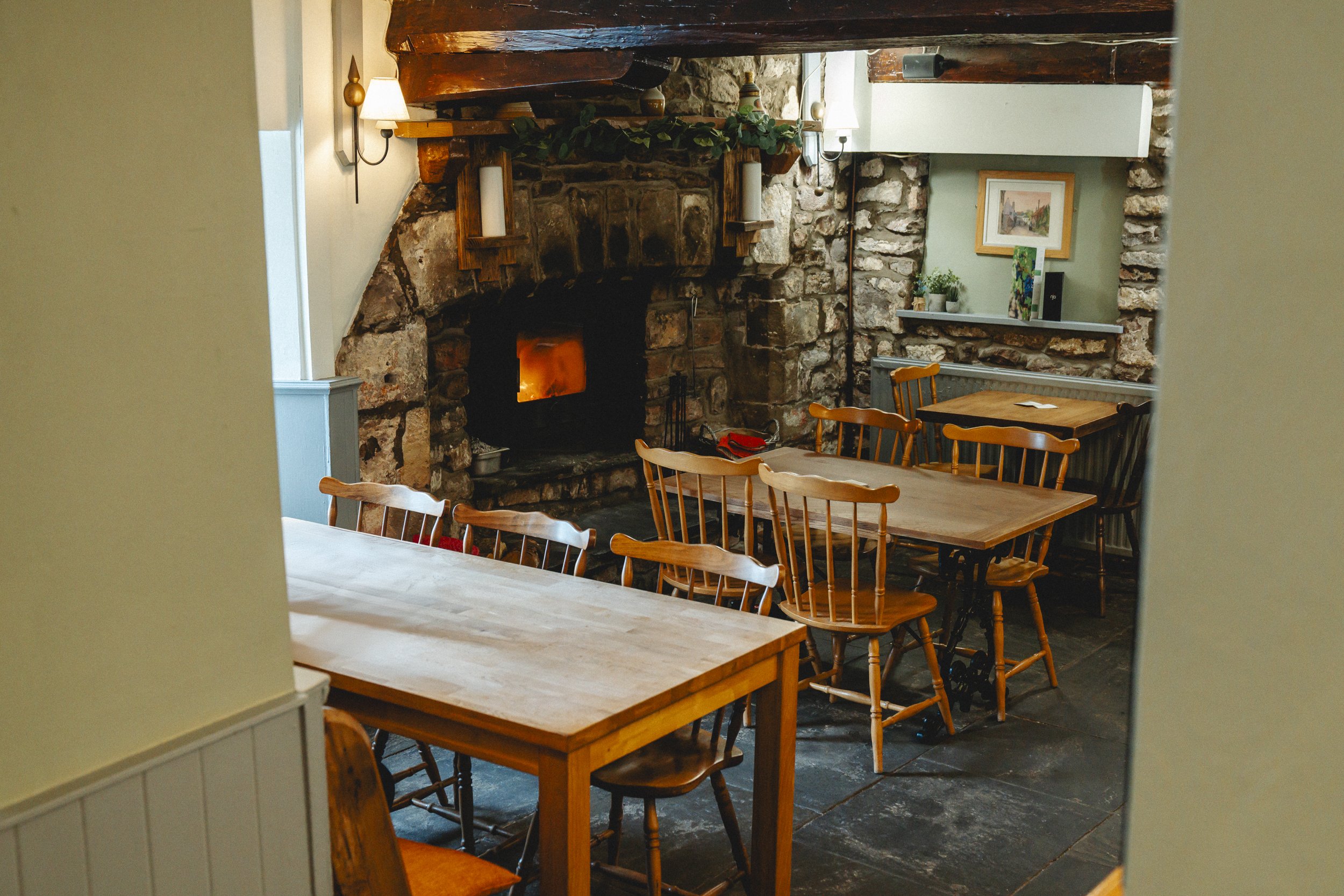Tables next to the log burner in the front bar area