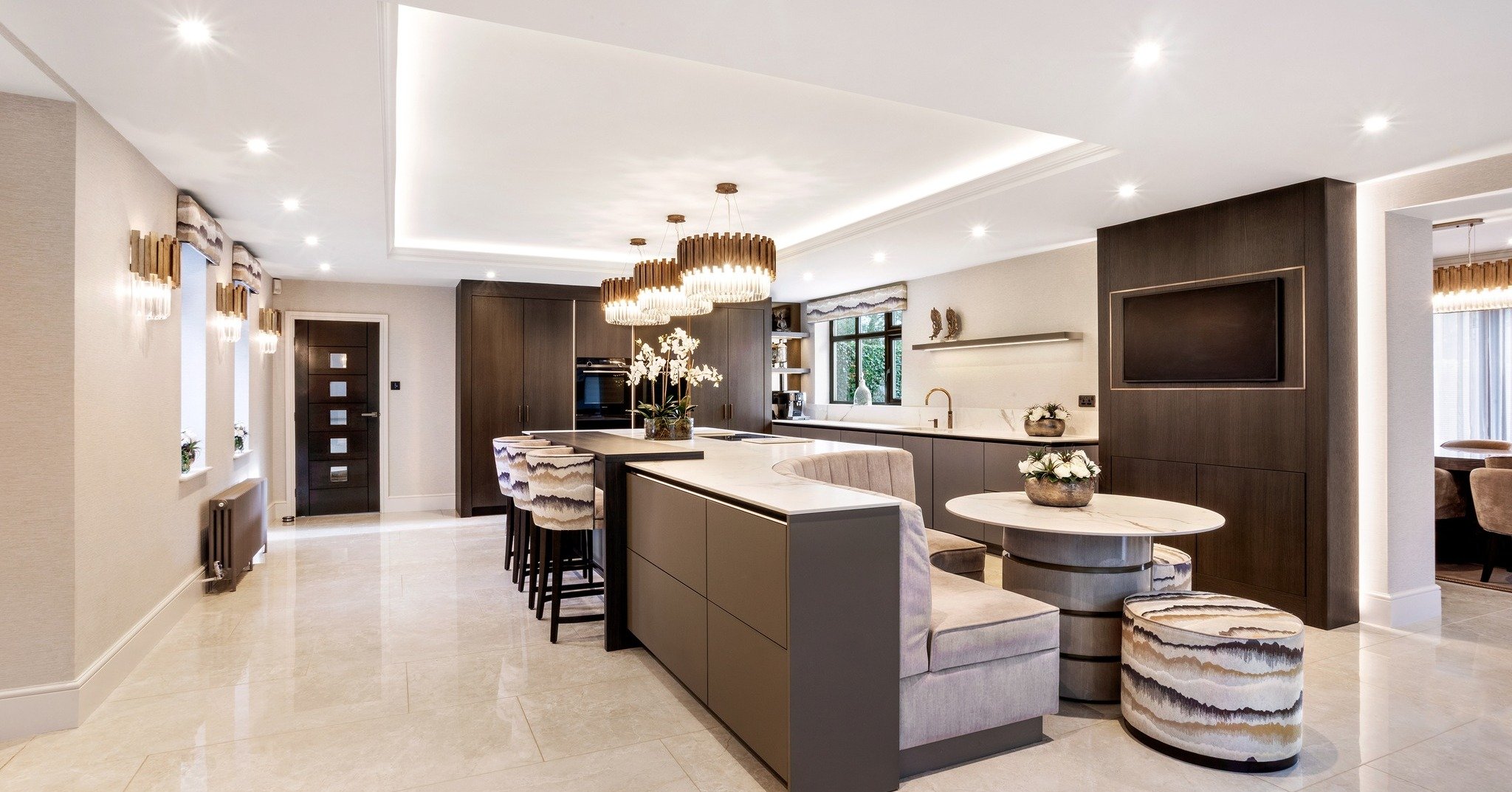 From a traditional country style to a modern luxury kitchen. The original layout&mdash;dominated by a curved, multi-level island and heavy traditional cabinetry&mdash;was completely stripped away. In its place sits a spectacular floor-to-ceiling suit