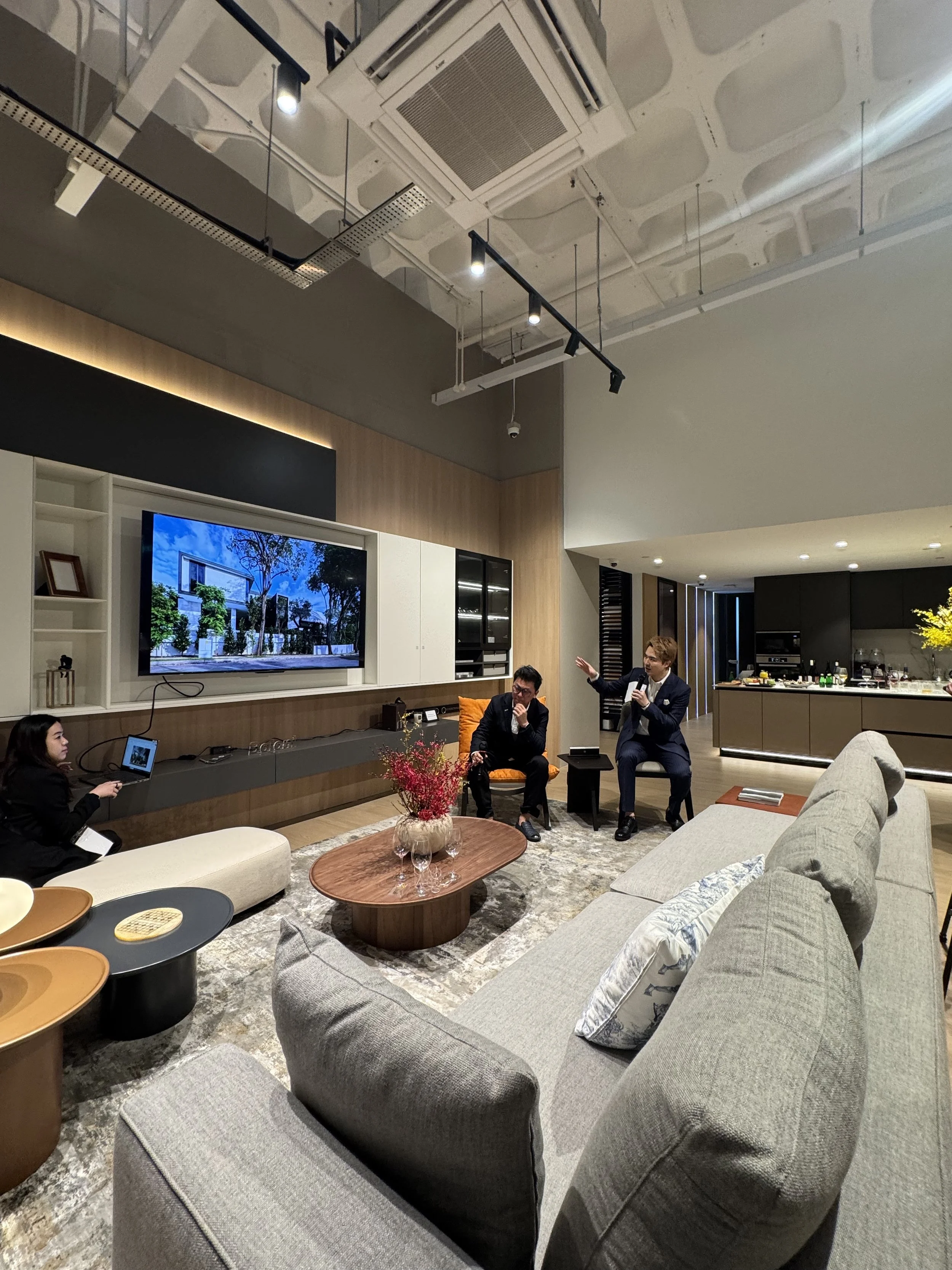 Group selfie of four people smiling indoors, holding a wine glass, at BOLONI International's event