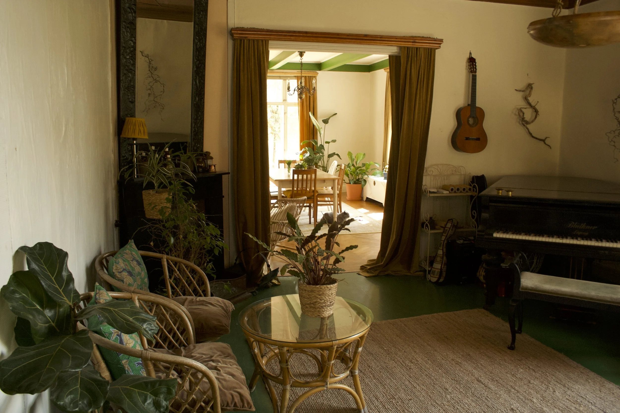 Living room with grand piano, acoustic guitar, and soon an upright bass.