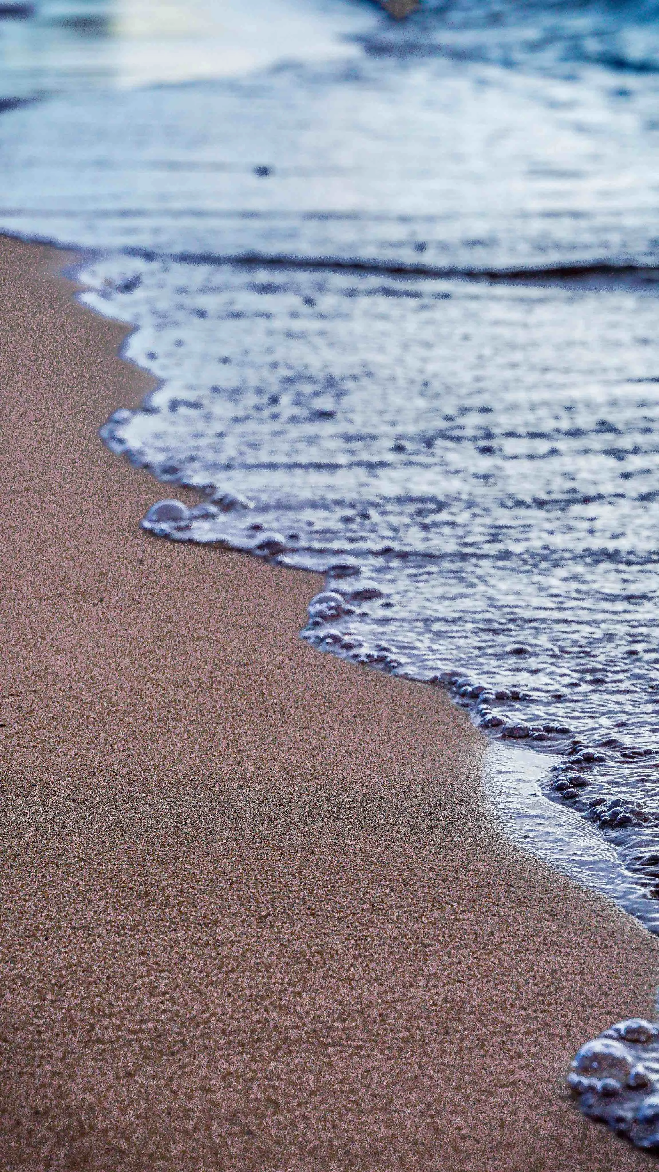 Shoreline at the edge of the sea, representing liminal space and life transitions