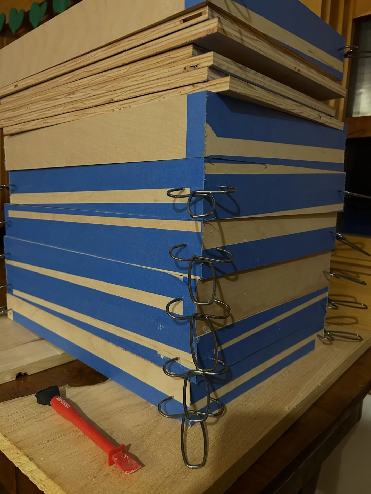 This is a stack of drawers to go in an existing kitchen. Adding firmly pressed blue tape helps make clean cuts on plywood. Plus the added benefit of having a nice place to write your thoughts, measurements, and ideas in a nice shade of blue.