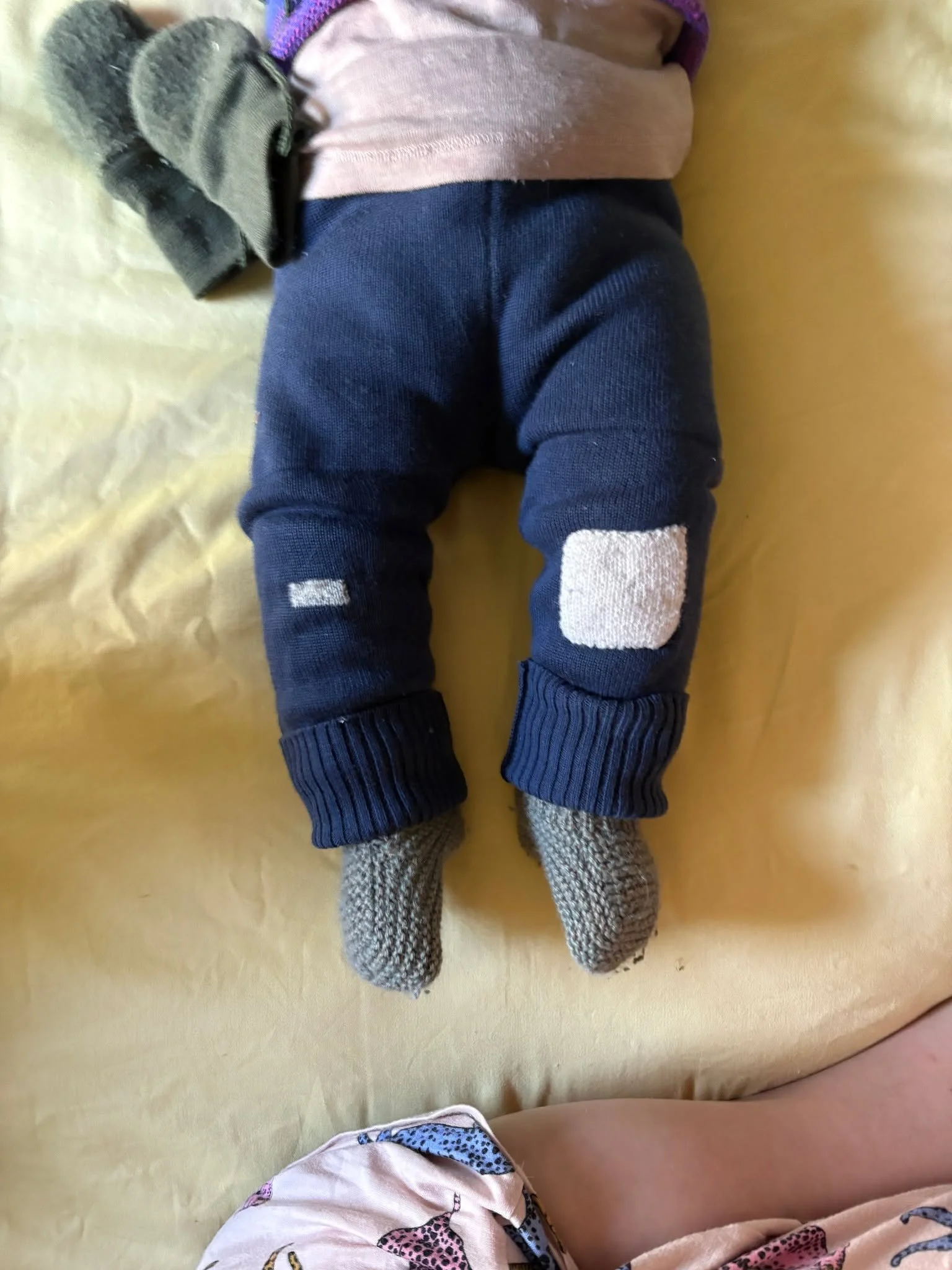 Baby mends! Tiny clothing needs tiny stitches. And sure, a baby outgrows clothing faster than an adult, but adults aren't constantly crawling around on their knees and propping themselves up with their elbows. Nothing cuter than lovingly reinforced l