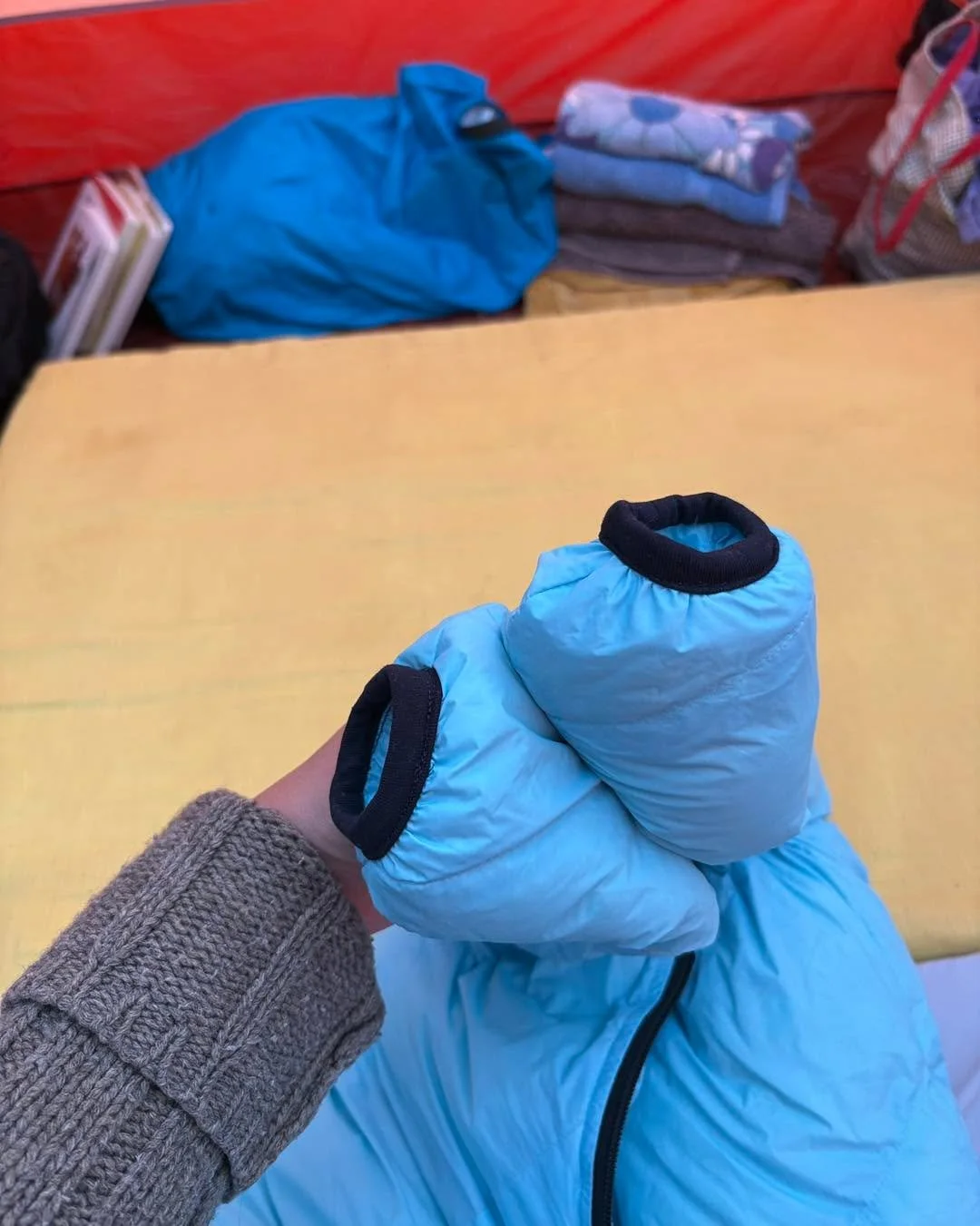 I found the baby sleeping bag very cheap (basically new) used, but it was the older model w/o the sleeve cuffs, the arms were sewn shut. Very grateful I figured out how to make the cuffs with some knit fabric. 

We also have a DIY latex pad that I se