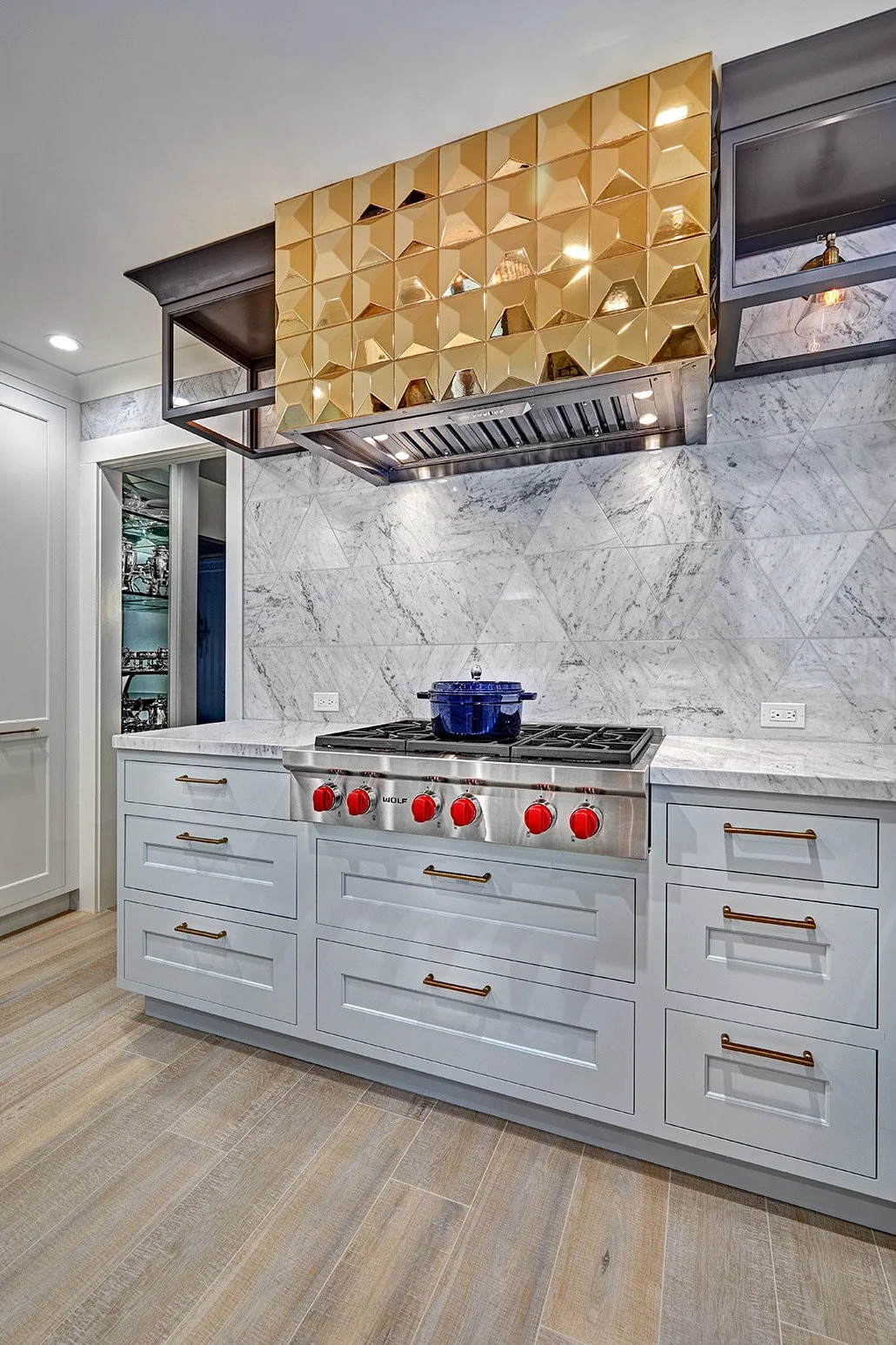 Whole home remodel, glamorous kitchen, white cabinetry, Wolf appliances, appliance garage, gold hood