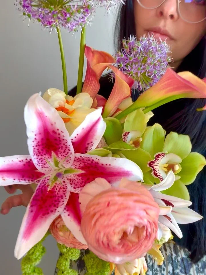 Recipe for this unique stunner bouquet: 
Orangey calla lilies, stargazer lilies, green amaranthus, purple allium, daffodils, green cimbidium orchid, peach ranunculus, parrot tulips 
#wedding #weddingflowers #ashevilleflorist #ashevillewedding #bouqu