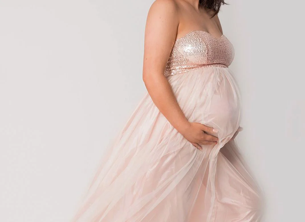 Portrait of pregnant woman in pink dress - maternity photography