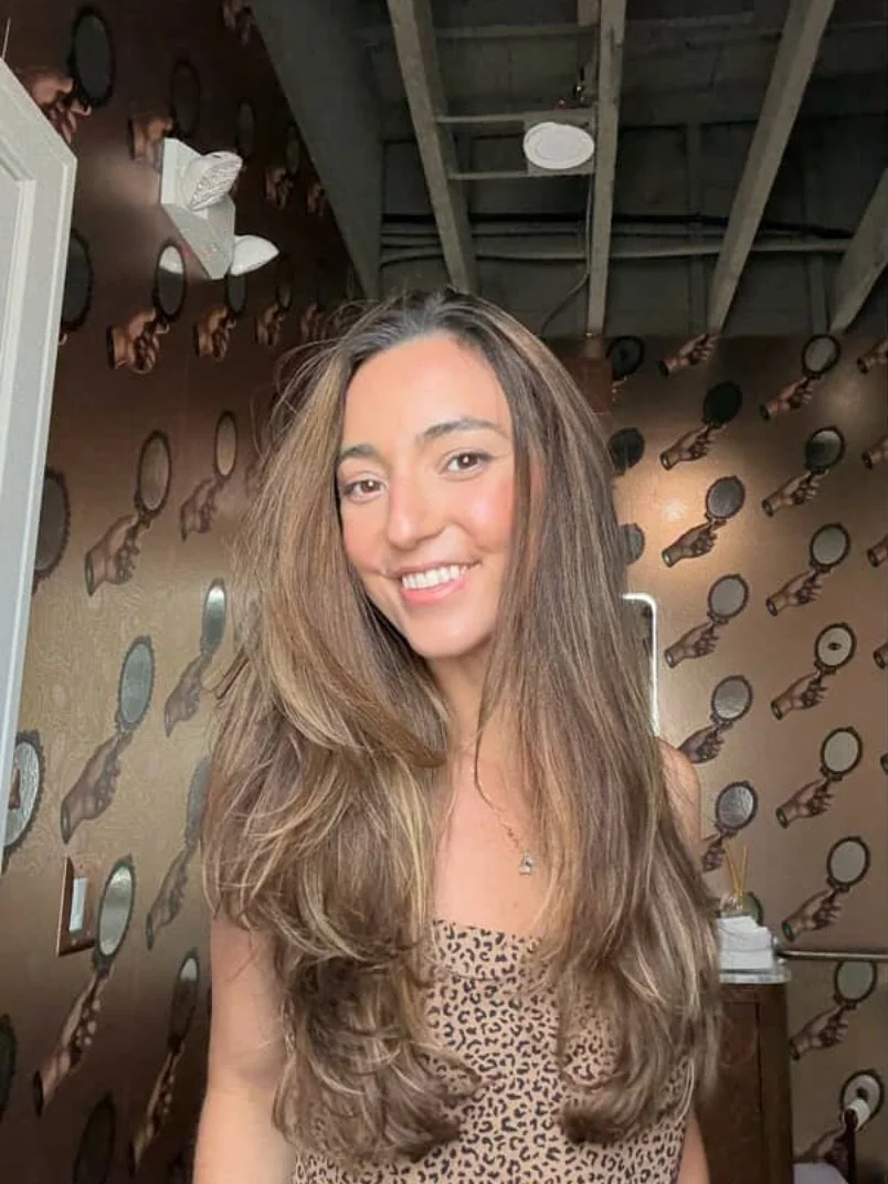 Hi, I’m Florena — but most people call me Flo 🌬️
I’m a co-stylist at Peter Marks Salon, and you can usually find me buzzing around like the Energizer Bunny — one minute helping clients settle in, the next mixing up color or
