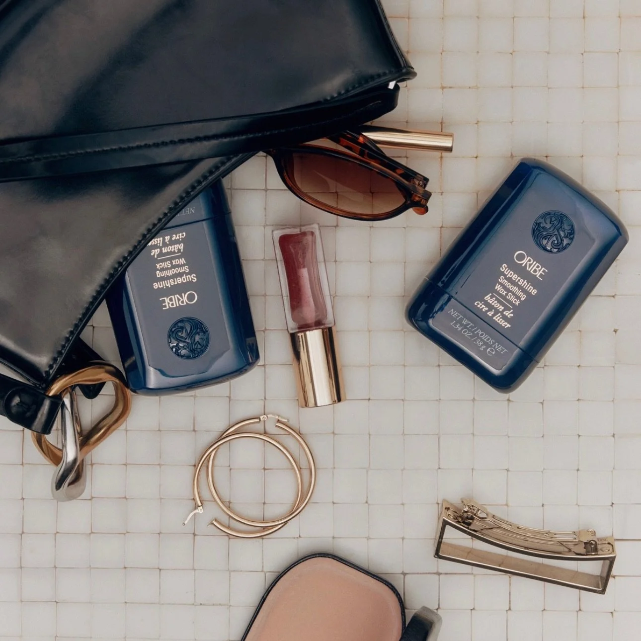 New from @oribe 🤍

Compact enough to fit in your pocket. Massive in impact.

Swipe on the Supershine Smoothing Wax Stick for instant smoothness, soft radiance,
and total control over even the most stubborn flyaways. #oribeobsessed