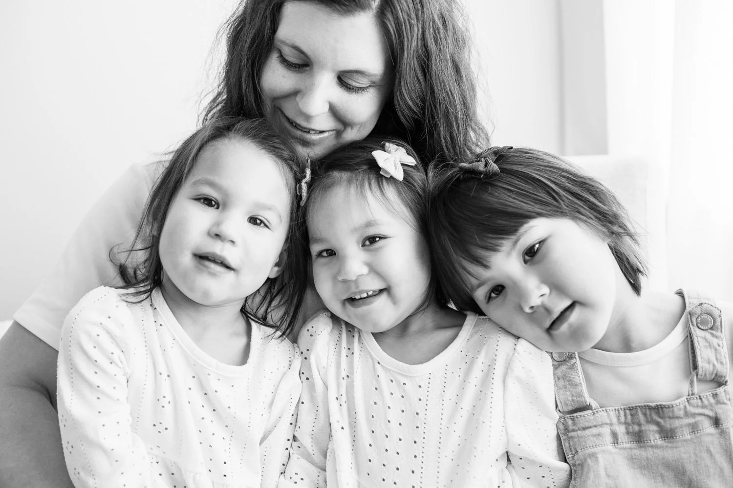 mom and three daughters in a studio black and white