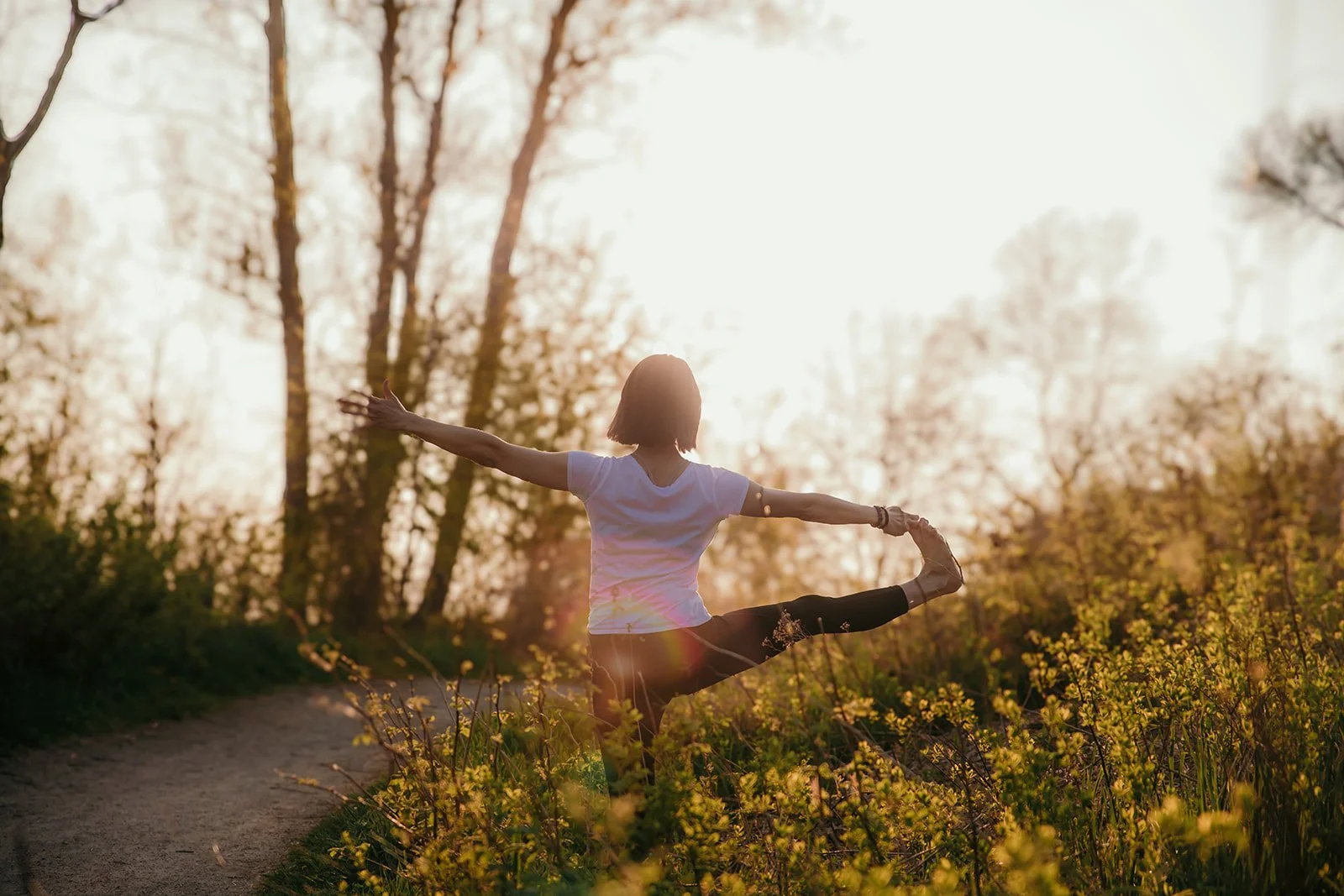 yoga instructor outside with a rainbow