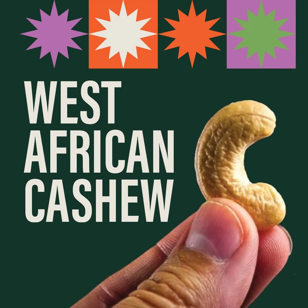 Close-up of a hand holding a raw cashew nut with a dark green background. Text reads 'West African Cashew' and decorative starburst icons at the top in purple, white, orange, and purple with green.