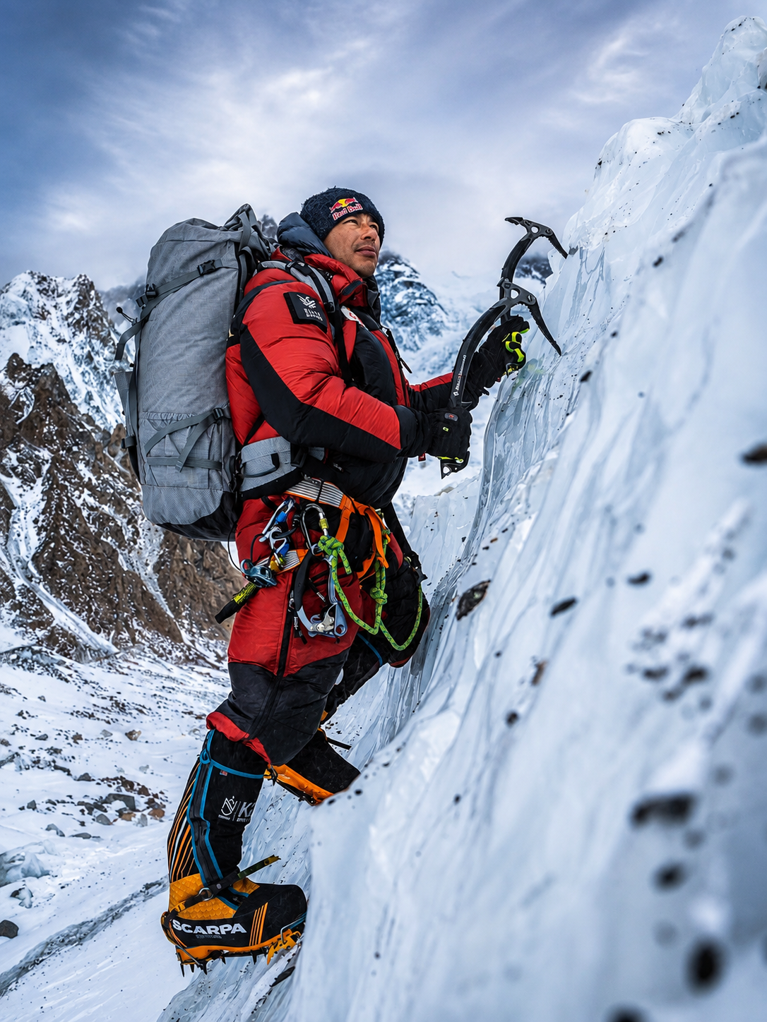 Nimsdai ascending a steep snow slope on a high-altitude mountaineering expedition using fixed ropes and technical climbing equipment.