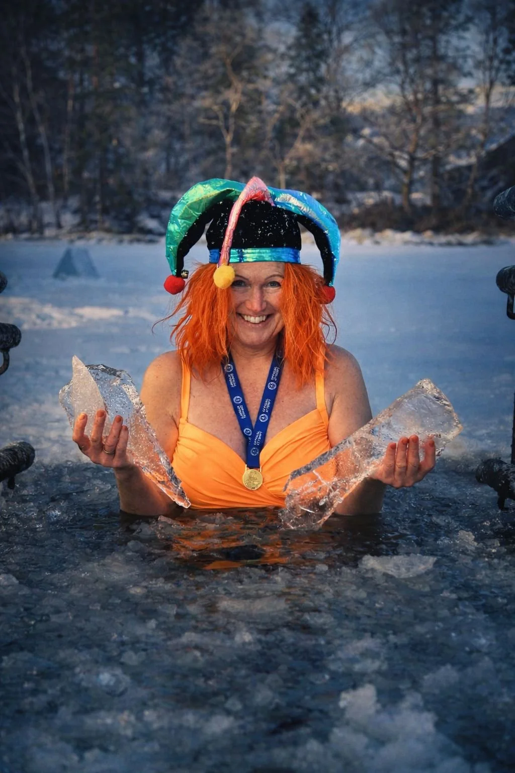 Solveig Fredriksen, Norwegian health coach from Sandnes, Rogaland, ice bathing in a frozen lake while wearing her Guinness World Record medal.