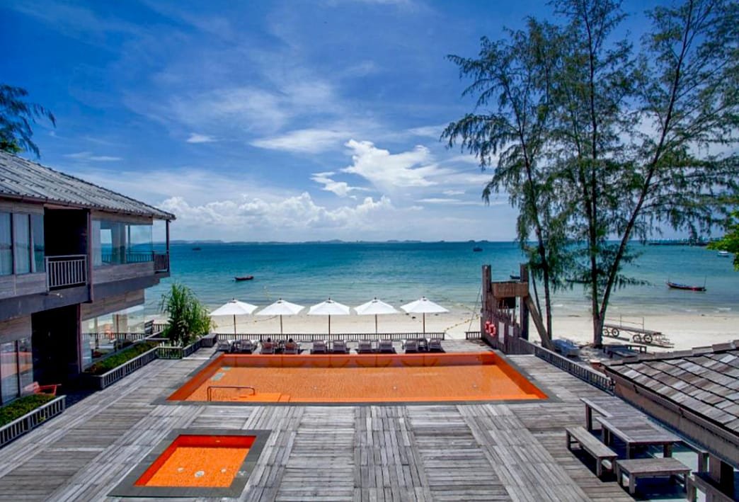 Beachfront view of Baan Ploy Sea Hotel in Koh Samed, showcasing its signature orange swimming pool overlooking the ocean.