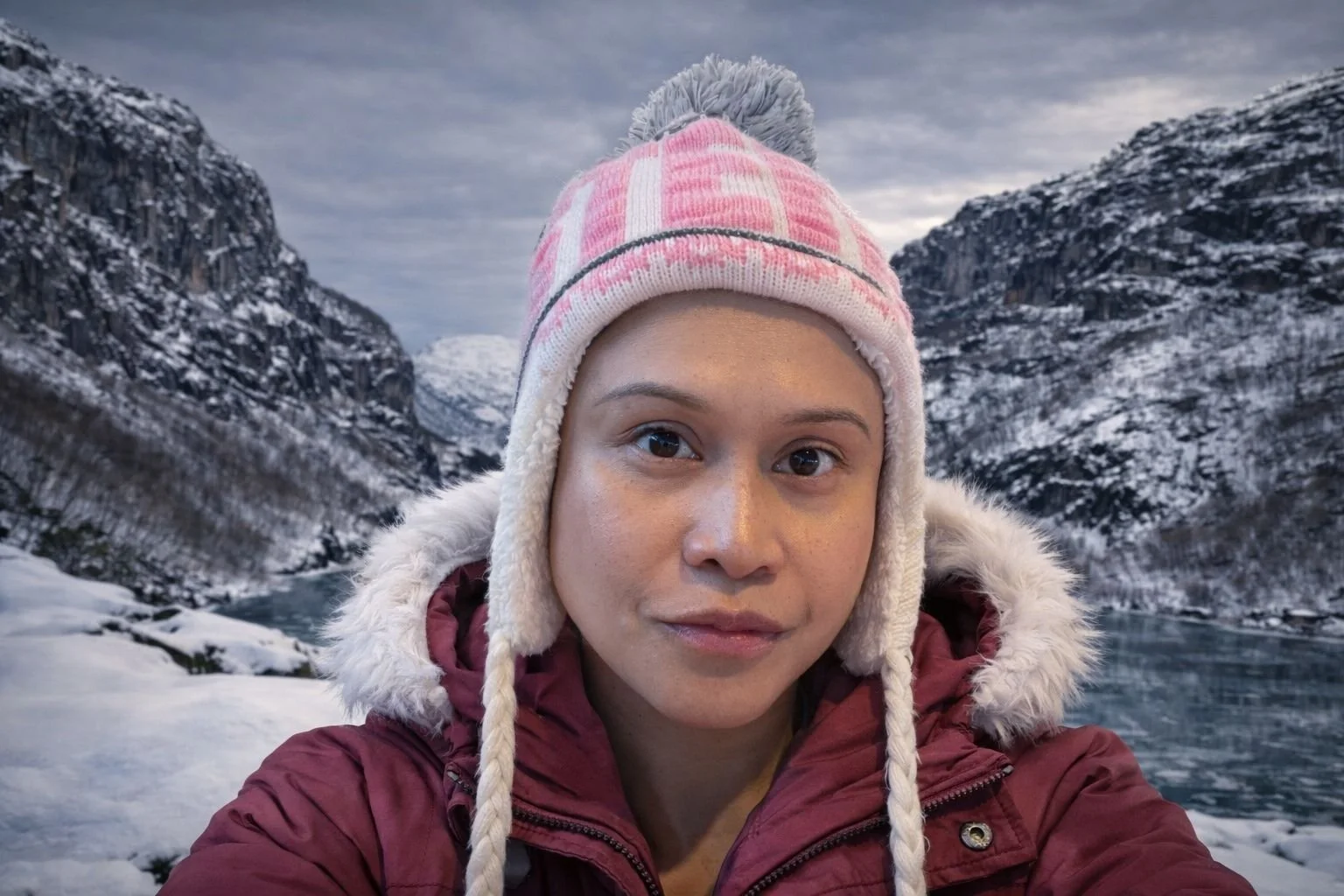 April Joy standing near frozen Dirdalsvatnet lake in Gloppedalsura valley, Rogaland, Norway.