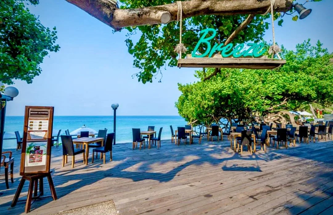 Beachfront dining area at Breeze Restaurant in Ao Prao Resort, Koh Samed, overlooking turquoise water and white sand
