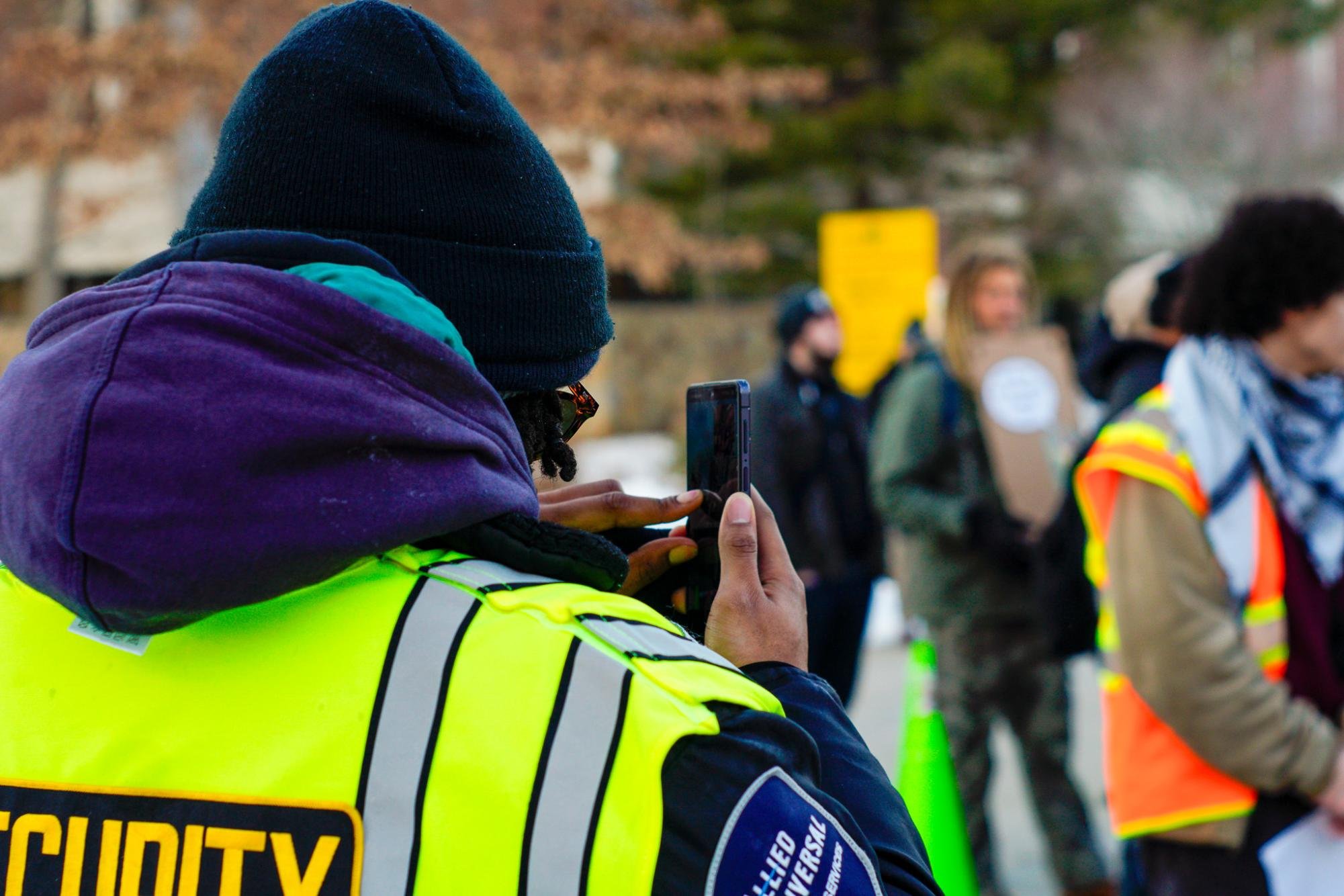  A security guard on a bike records the protest. Thurs. Feb 5, 2026. (Photographer: Nick DiCicco) 
