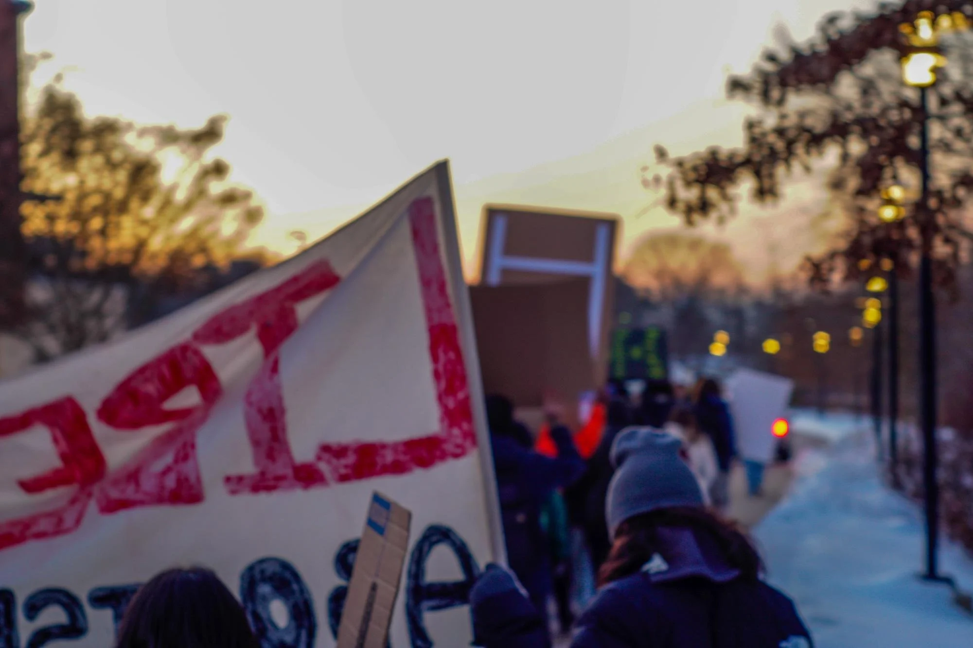  The sun starts to set as protestors peacefully march from Owl Statue to Business Hall. Thursday, Feb 5, 2026. (Photographer: Nick DiCicco)  