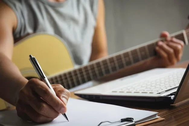 composer-holding-pencil-writing-lyrics-paper-musician-playing-acoustic-guitar_43284-1924.jpg