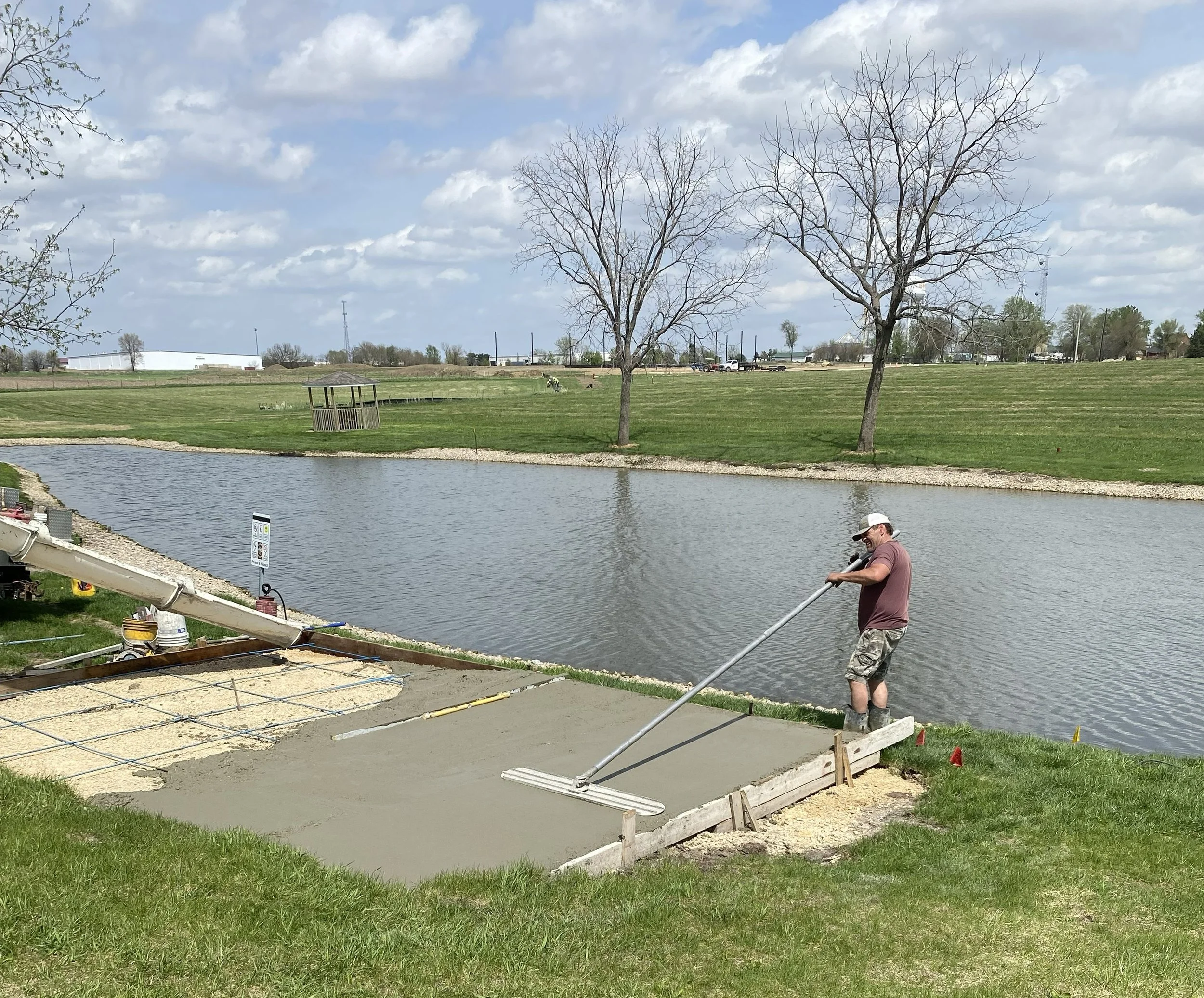 2026-4-23 Greg Butteris and Mason Stine pouring concrete pad for pavilion in Pleasant Grove Heritage Park