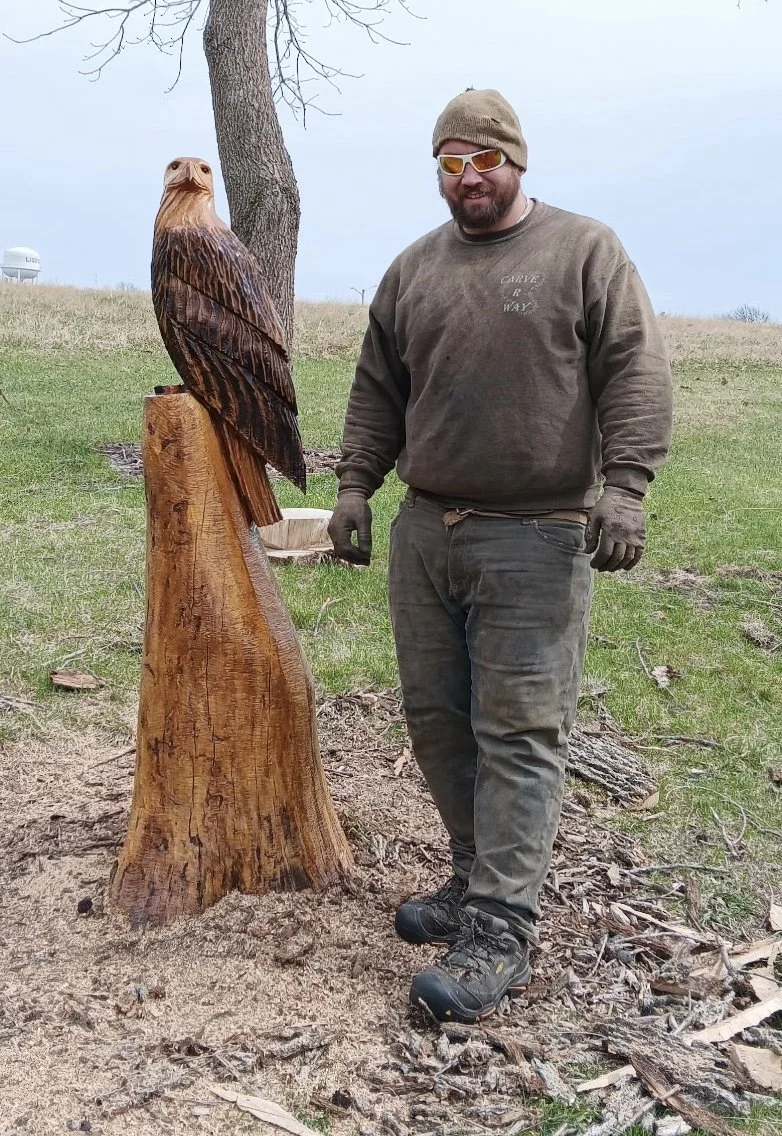 2026-4-1 Clint Henik of Carv R Way carving eagle at Pleasant Grove Heritage Park in Lisbon, IA.