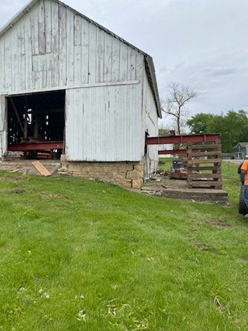 5/5/2026 Meyers Farmstead Historic District corn crib/hog barn starting restoration with lifting the barn to allow for restoration work on the foundation.