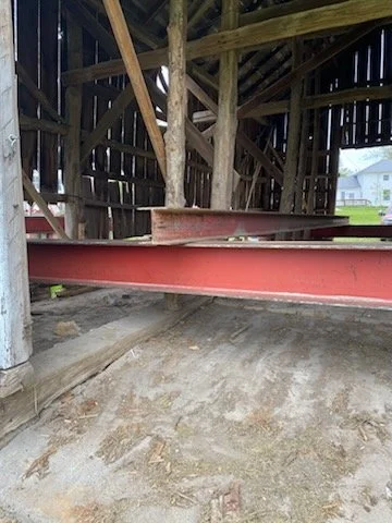 5/5/2026 Meyers Farmstead Historic District corn crib/hog barn starting restoration with lifting the barn to allow for restoration work on the foundation.