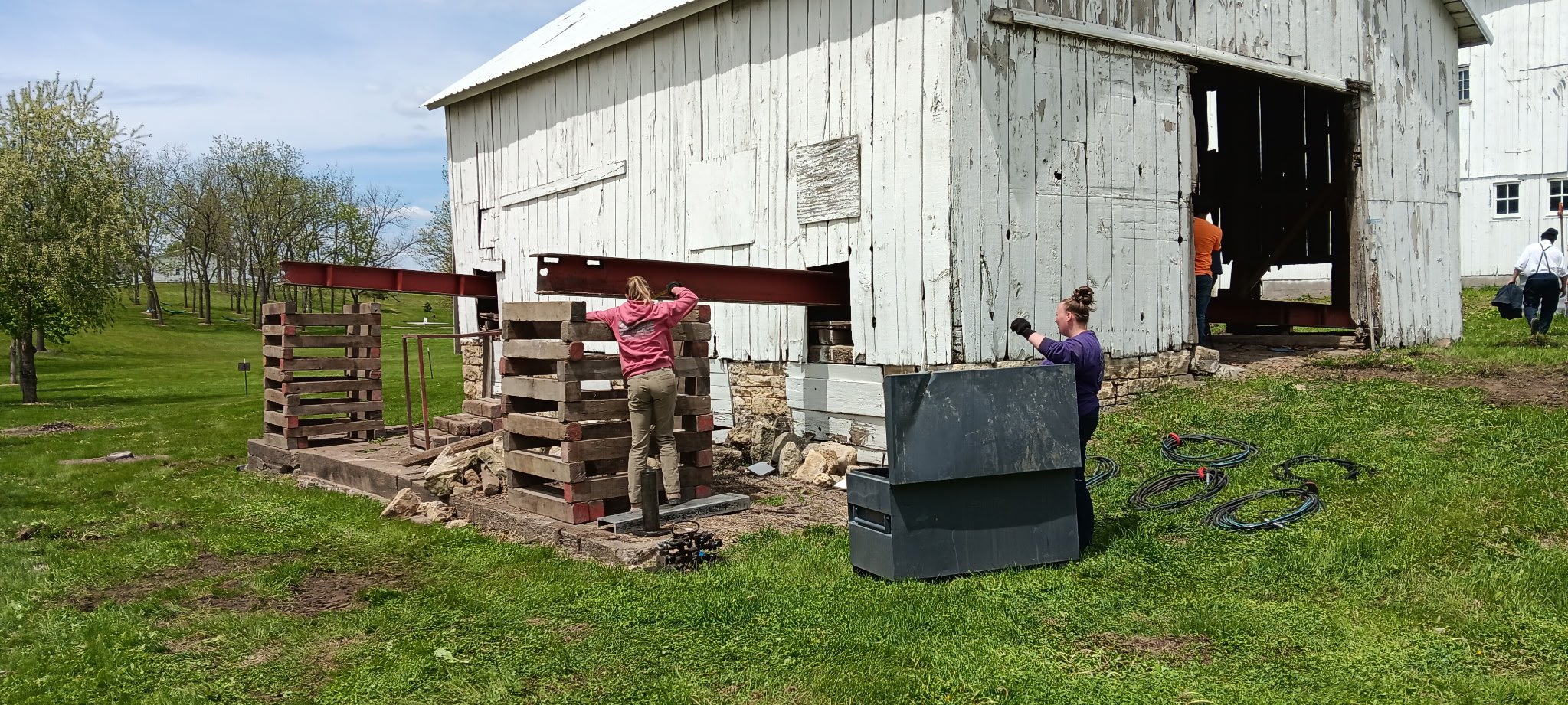 5/5/2026 Meyers Farmstead Historic District corn crib/hog barn starting restoration with lifting the barn to allow for restoration work on the foundation.