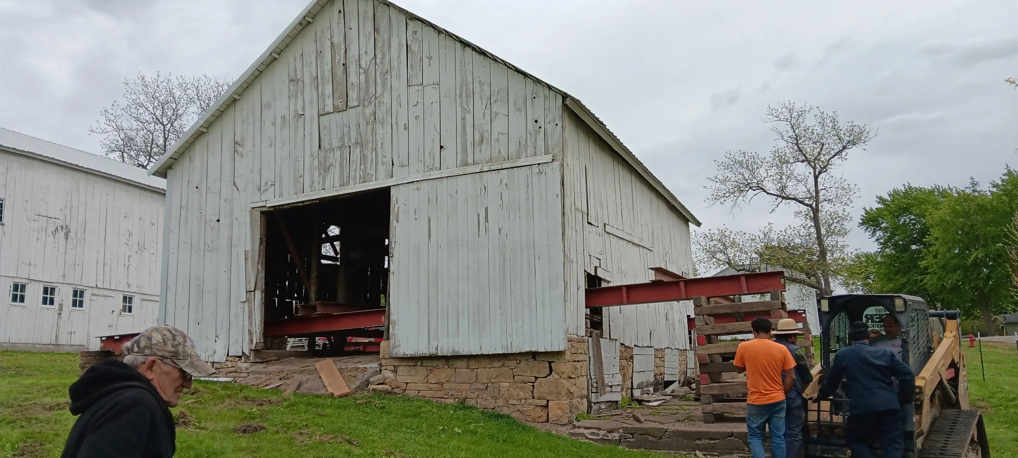 5/5/2026 Meyers Farmstead Historic District corn crib/hog barn starting restoration with lifting the barn to allow for restoration work on the foundation.