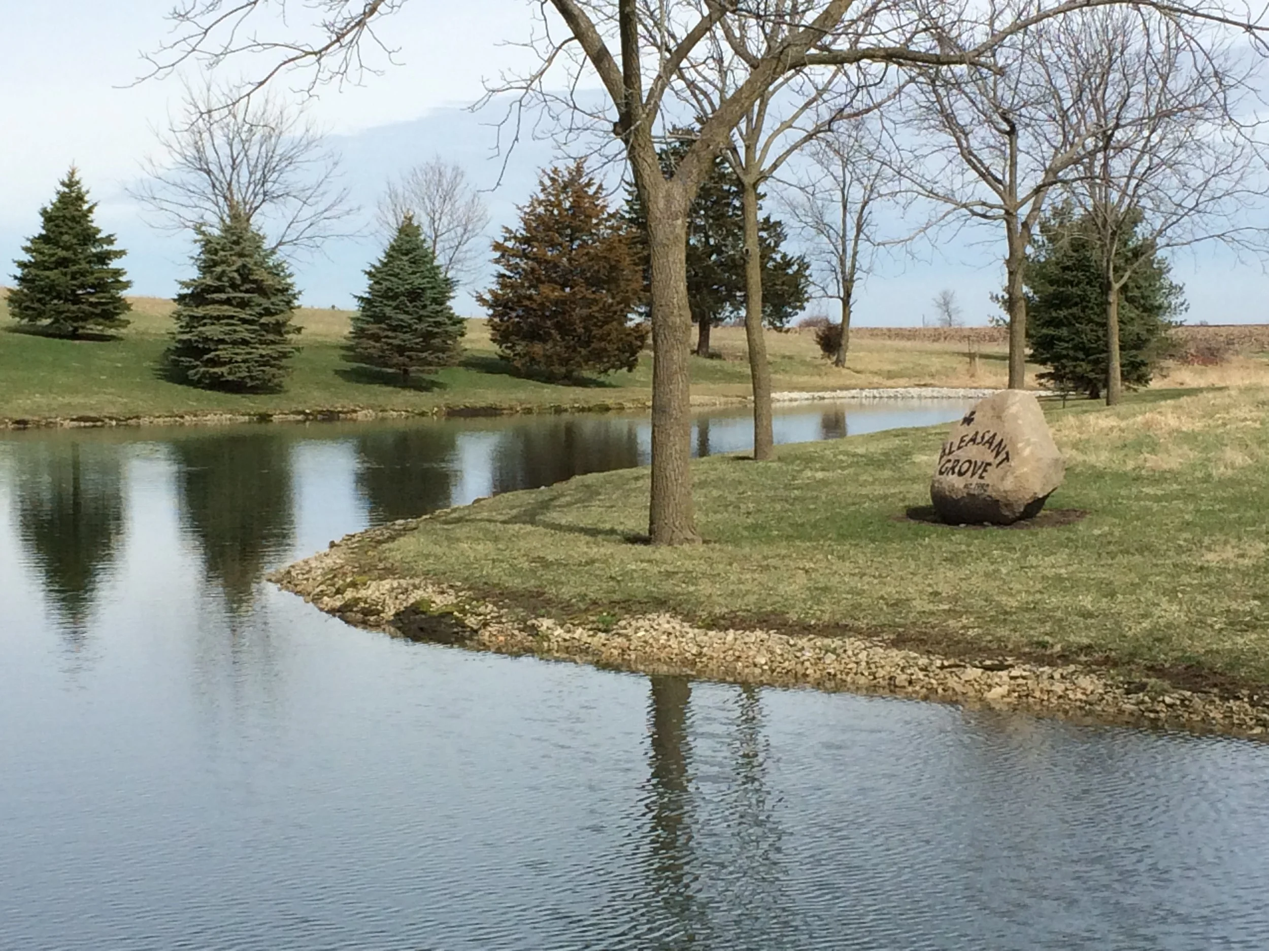 Pleasant Grove Heritage Park pond, trees and engraved rock