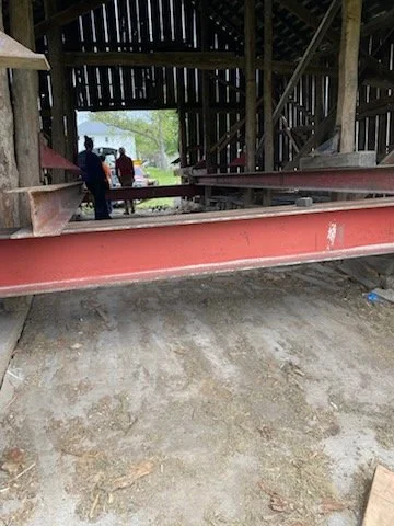 5/5/2026 Meyers Farmstead Historic District corn crib/hog barn starting restoration with lifting the barn to allow for restoration work on the foundation.