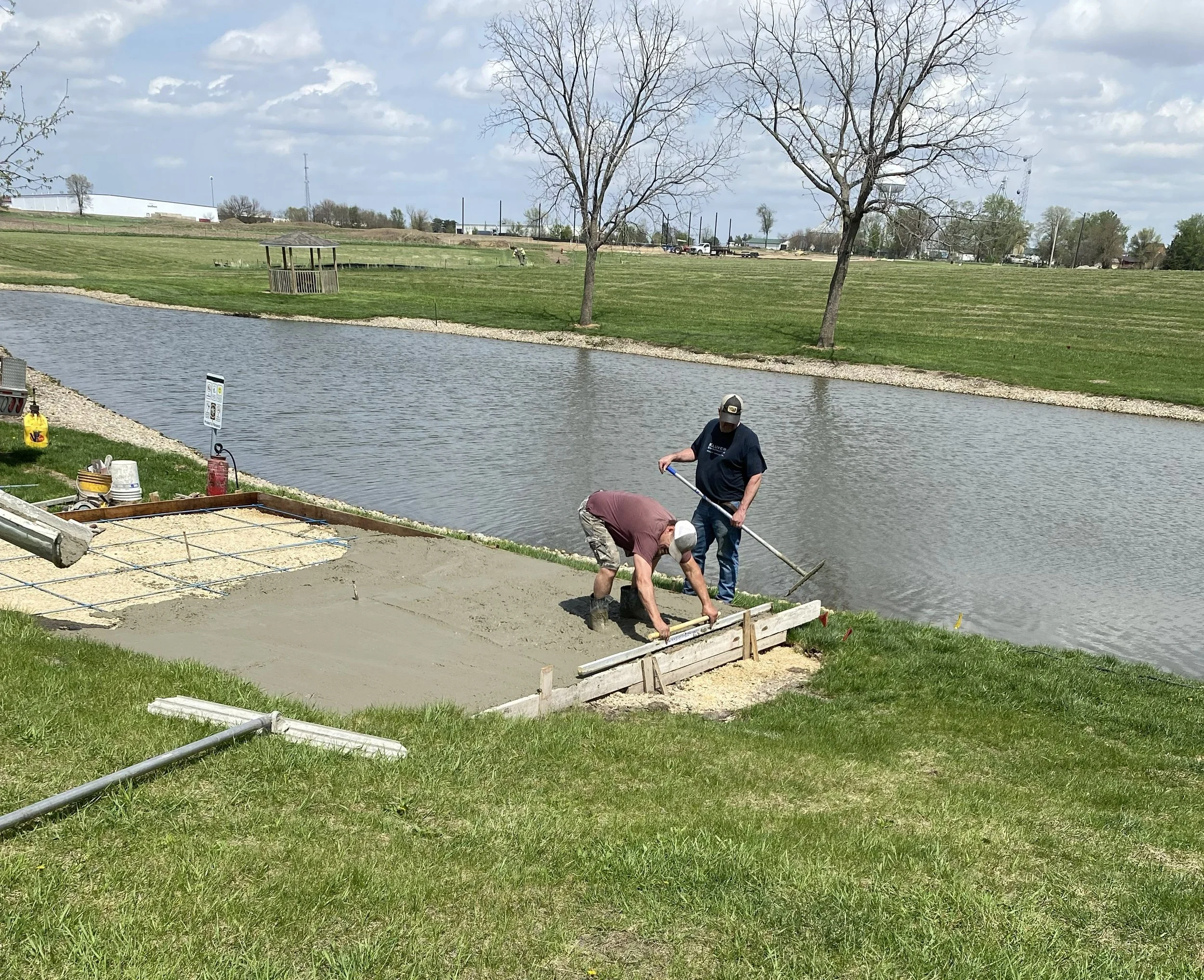 2026-4-23 Greg Butteris and Mason Stine pouring concrete pad for pavilion in Pleasant Grove Heritage Park