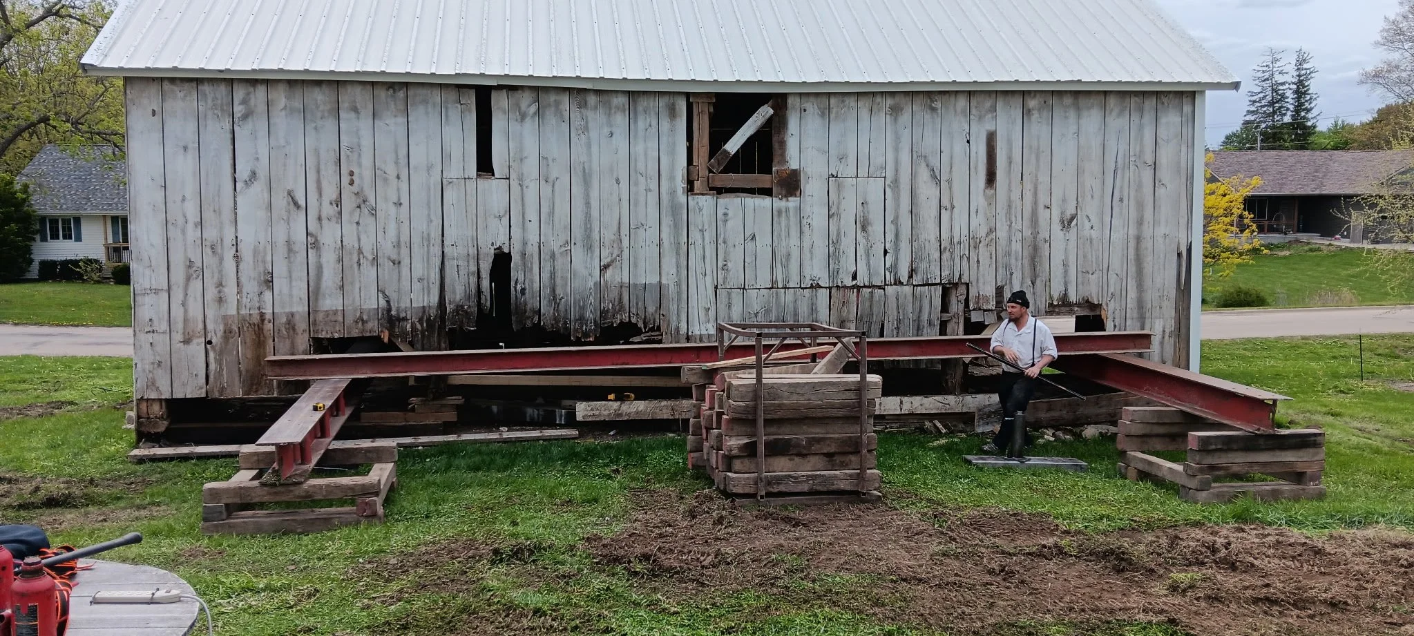 5/5/2026 Meyers Farmstead Historic District corn crib/hog barn starting restoration with lifting the barn to allow for restoration work on the foundation.