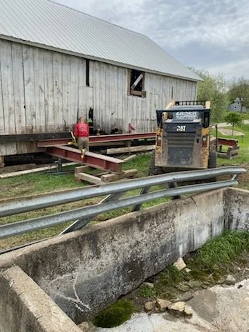 5/5/2026 Meyers Farmstead Historic District corn crib/hog barn starting restoration with lifting the barn to allow for restoration work on the foundation.