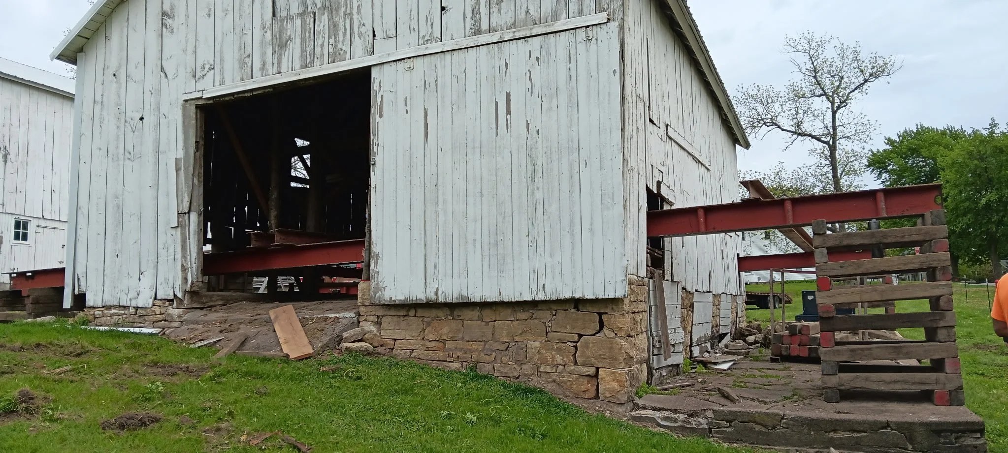 5/5/2026 Meyers Farmstead Historic District corn crib/hog barn starting restoration with lifting the barn to allow for restoration work on the foundation.