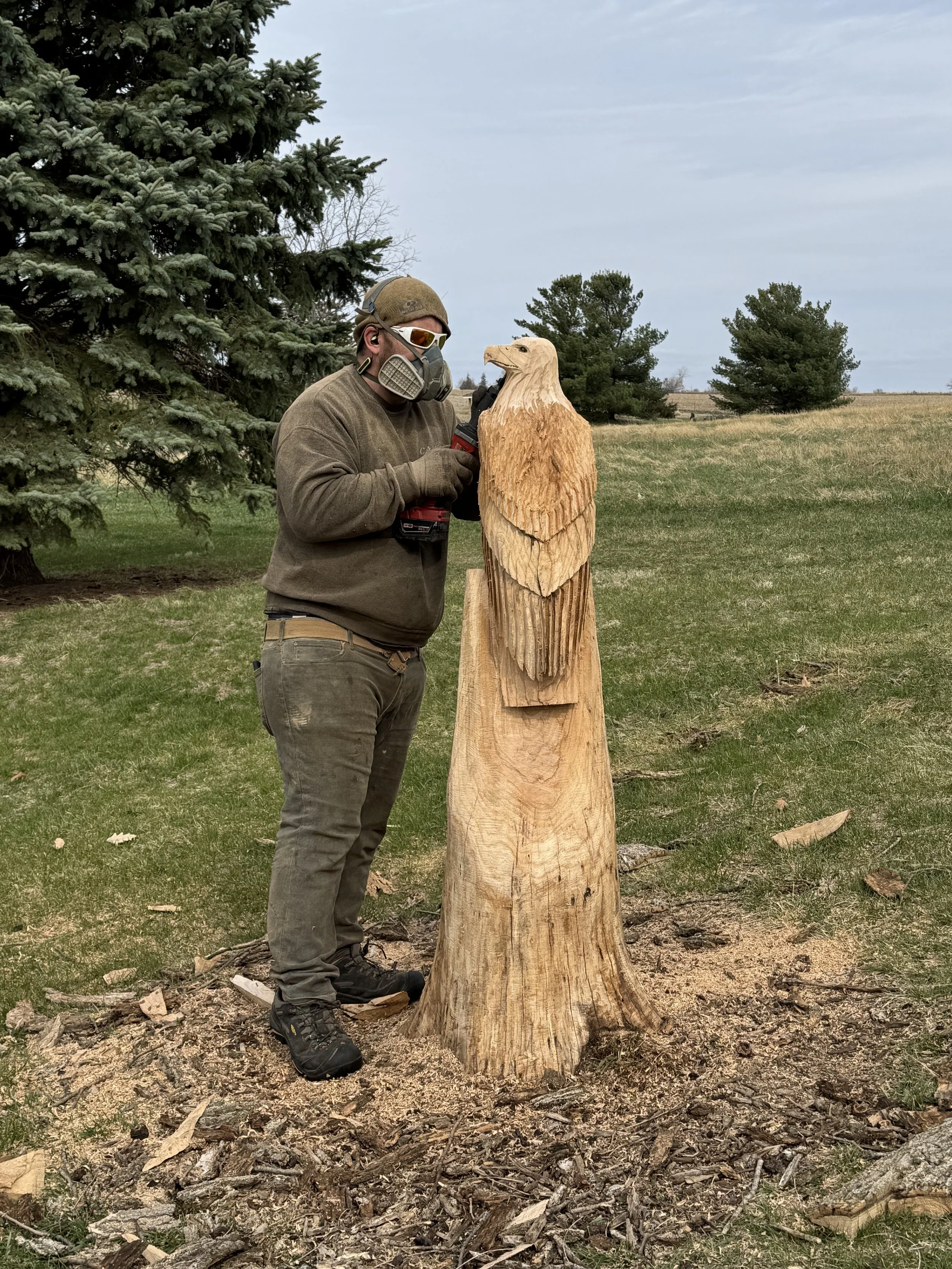 2026-4-1 Clint Henik of Carv R Way carving eagle at Pleasant Grove Heritage Park in Lisbon, IA.