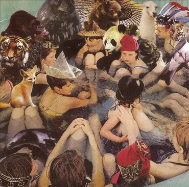 Children and dogs in a crowded hot tub or pool, wearing swimsuits and various accessories. Album art.