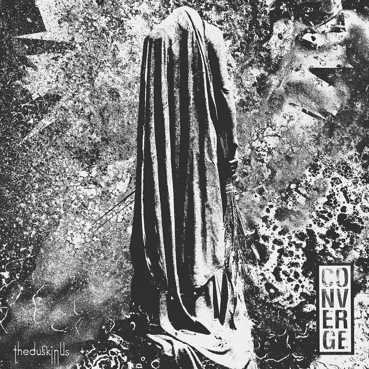 Black and white artistic depiction of a cloaked figure with a hooded face, surrounded by abstract textures and patterns, with the words 'Converge' and 'The Dusk In us'. Album art.