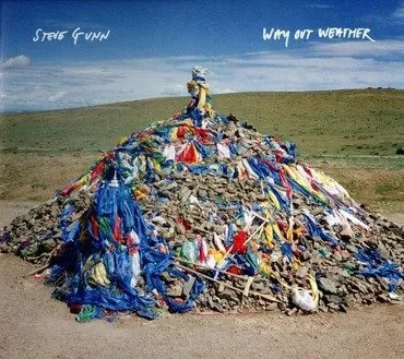 A mound of trash and debris with a sign on top. The text reads 'Steve Gunn' and 'Way Out Weather.'