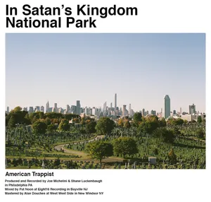 Panoramic view of New York City skyline from Satan's Kingdom National Park, with trees and greenery in the foreground. Album Cover.