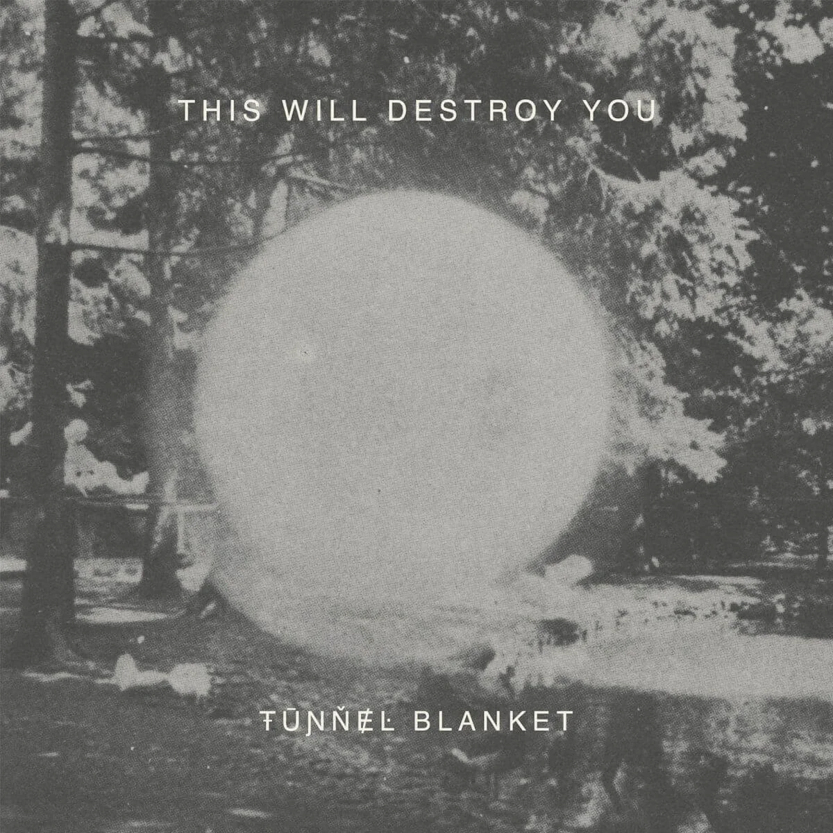 A black and white photo of a campfire within a tunnel, surrounded by trees, with the text 'This will destroy you' at the top and 'Tunnel Blanket' at the bottom. Album artwork.