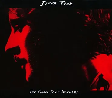 Silhouette of a man's face with a beard in profile, and a small animal, possibly a fox, in the lower right corner. The background is mostly red and black. Text reads 'Deer Tick' and 'The Black Dirt Sessions'. Album art.