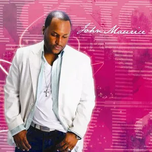 A man wearing a white suit jacket and white shirt standing against a pink background with abstract graphics and cursive text reading 'John Maurice'.
