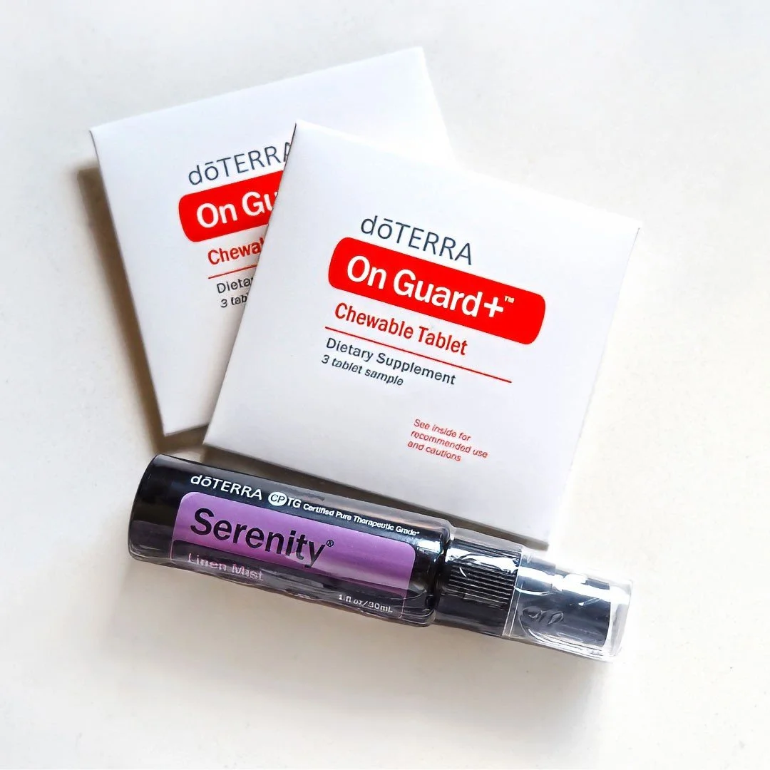 Two boxes of doTERRA On Guard chewable tablets and a doTERRA Serenity linen mist spray on a white background.