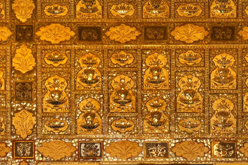 Intricate golden decorative panel with floral and geometric patterns.