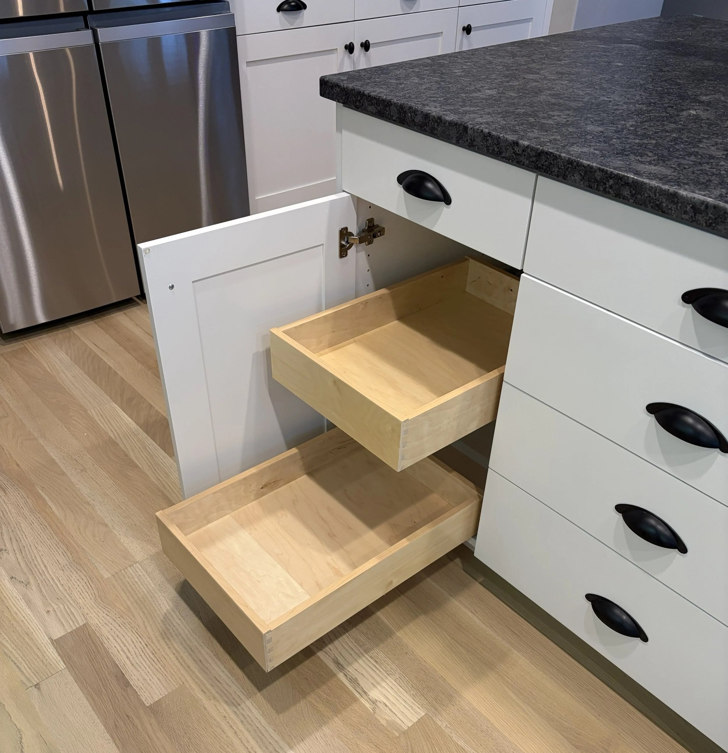 dovetail baltic birch pullout shelves installed in a base cabinet with blum tandem drawer slides
