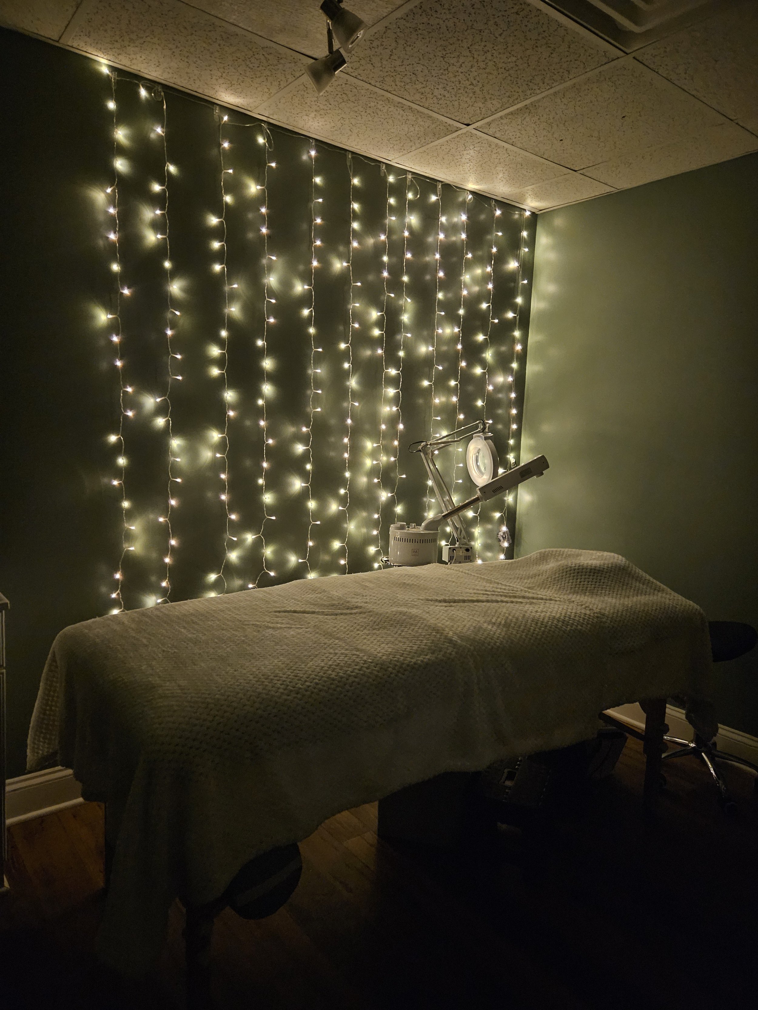 A warm inviting treatment room inside of Sonage Salon and Day Spa in Dunn, NC where esthetic treatments ranging from facials to waxing are offered by a friendly esthetician.